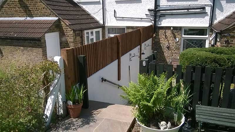 wood fence on top of garden wall by Paul Timms Fencing